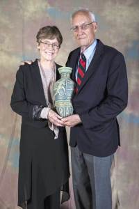Judy and John Collins, at their induction into the USA Triathlon Hall of Fame in 2014. Triathletes from California, they introduced the triathlon to Hawaii on February 18, 1978 by creating and staging the first endurance tyriathlon, The Hawaii Ironman Triathlon, a swim/bike/run course that circled the island of Oahu. The Ironman course linked the minimum 2.4mile Waikiki Roughwater Swim, an estimated 112 miles of the 115 mile Round Oahu Bike Course and the 26.2 mile Honolulu Marathon (Photo: courtesy Judy and John Collins)