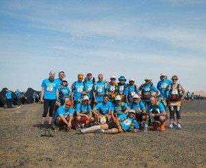 Girish (fourth from right, back row) with his German and Austrian tent mates at the Marathon des Sables. The blue UNICEF T-shirts is for the last day's charity run (Photo: courtesy Girish Mallya)