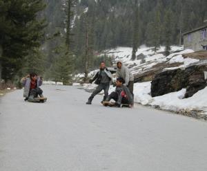 Youngsters with improvised summer luges on the hill slopes near Manali (Photo: courtesy Shiva Keshavan)