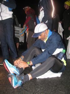 Cdr. Sunil Handa of the Indian Navy gets back into running shoes after crossing the waterlogged stretch of road (Photo: Shyam G Menon)